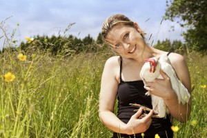 woman hugs an white chicken, horizontal
