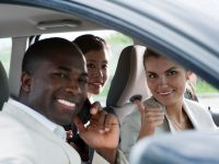 Multi-ethnic businesspeople sharing a car